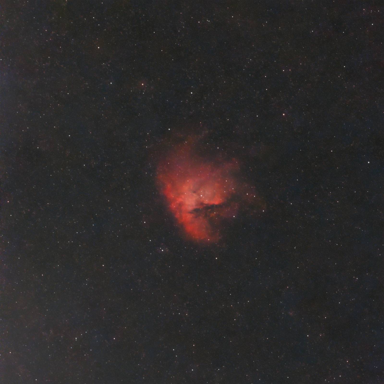 The glowing star-forming cloud and dark dust lanes of the Pacman Nebula